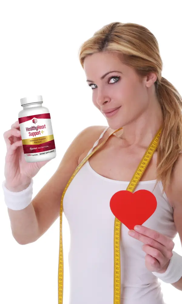 Woman holding HealthyHeart Support+ bottle and red heart symbol representing cardiovascular wellness in USA